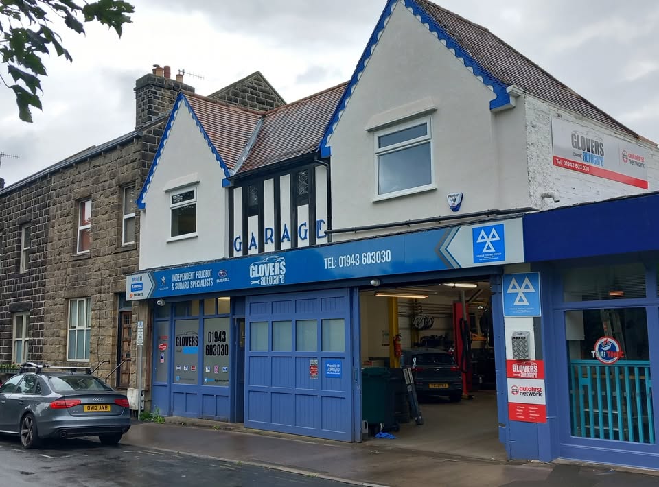 Glovers Autocare garage and blue workshop doors on Bridge Lane in Ilkley